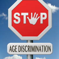 A stop sign that reads age discrimination