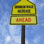 minimum wage increase ahead road sign