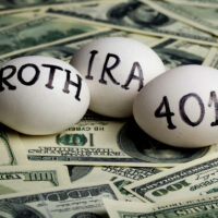 Three Eggs with the Inscription "Ira Roth 401K" on Money