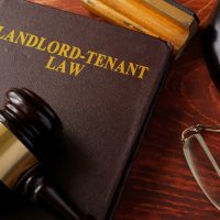 Book with title Landlord-Tenant Law and a gavel.