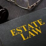 Book estate law and gavel on a table. Book estate law and gavel on a table.